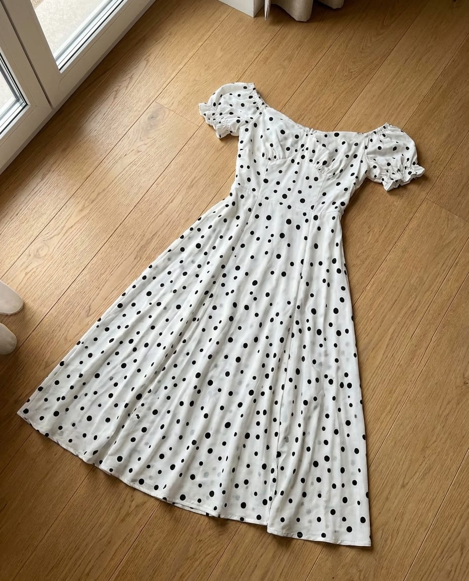 A dress photographed lying on the floor at home